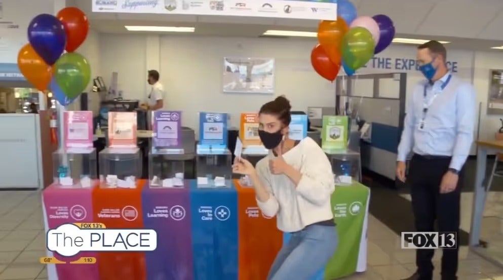 Colorful recycling and collection stations at a Mark Miller Subaru community event
