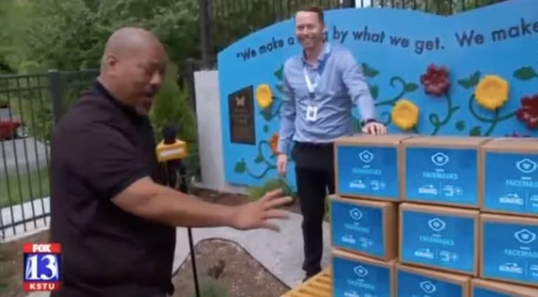 Mark Miller Subaru staff handing off donation boxes outside the retailer