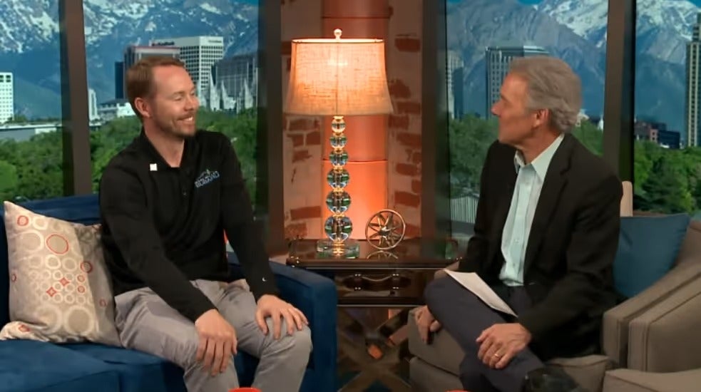 Mark Miller Subaru representative being interviewed on a television set